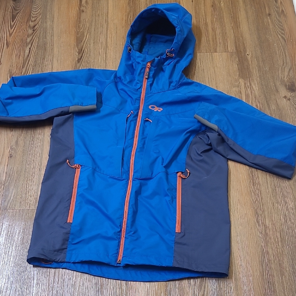 Outdoor Research Blue and Gray men Raincoat used good condition.
